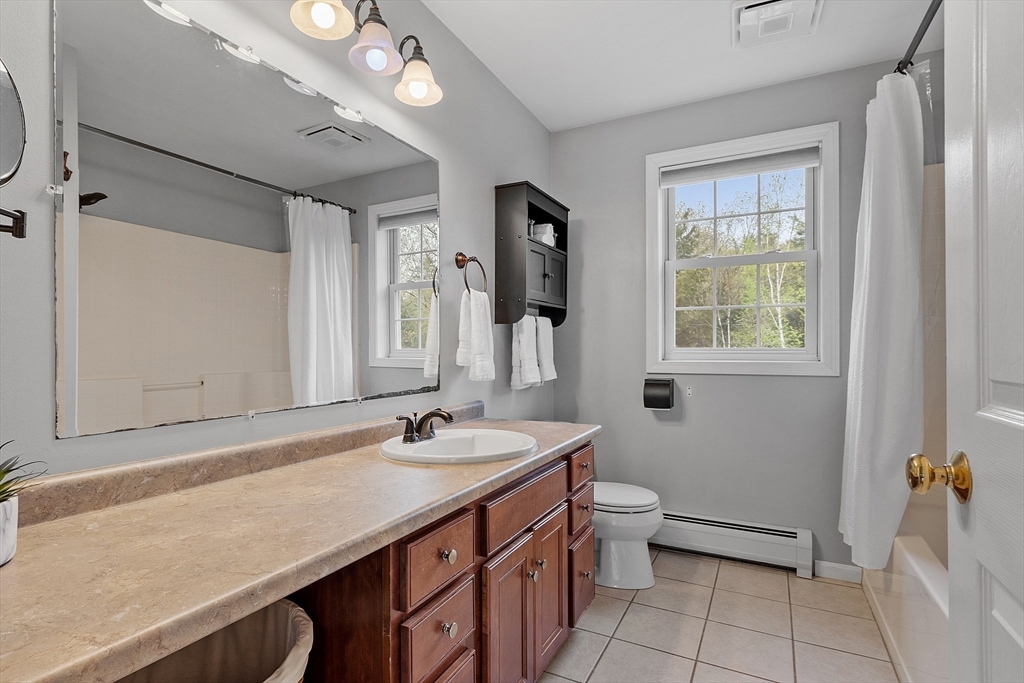30 Page Epping, NH 03042 - Photo 18 of 42 a bathroom with a sink a toilet and a mirror