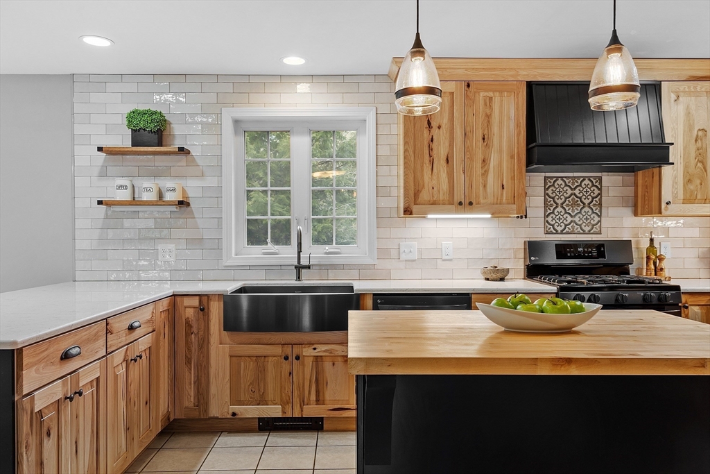 30 Page Epping, NH 03042 - Photo 4 of 42 a kitchen with stainless steel appliances a sink stove and cabinets