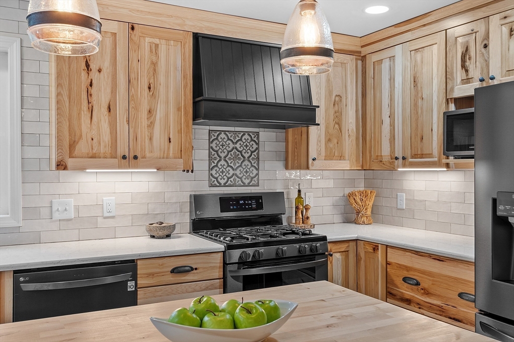 30 Page Epping, NH 03042 - Photo 6 of 42 a kitchen with stainless steel appliances a stove and a refrigerator