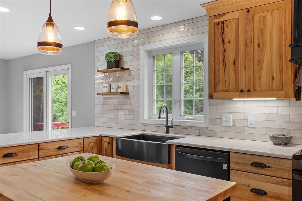 30 Page Epping, NH 03042 - Photo 7 of 42 a kitchen with stainless steel appliances a sink a counter space and a window