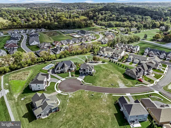 a living room with furniture kitchen view and a chandelier
