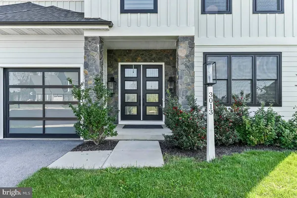 a front view of a house with plants