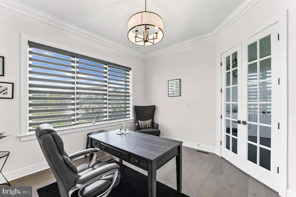 a bedroom with a large bed and a chandelier fan
