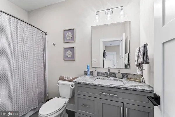 a living room with a bed and a flat screen tv