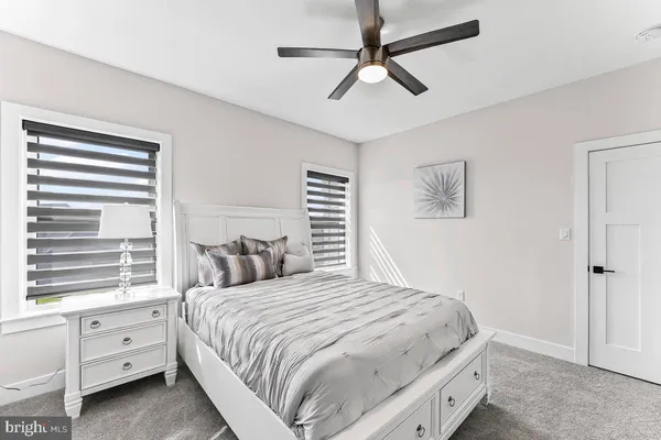 a bedroom with a bed chandelier and a window