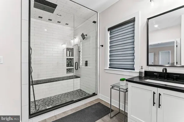 a bathroom with a granite countertop sink a toilet and a mirror
