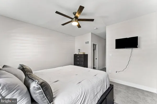 a bathroom with a granite countertop toilet sink and mirror
