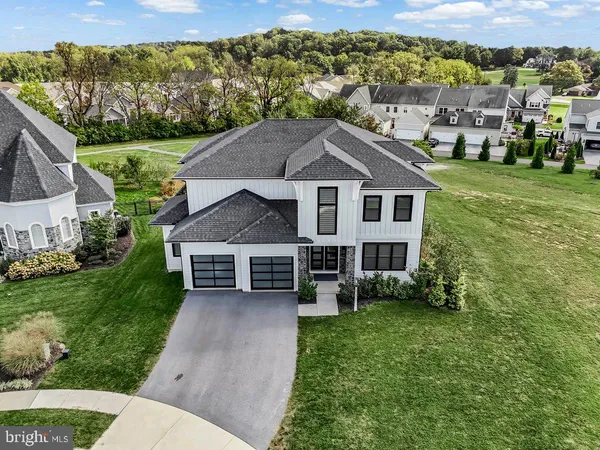 a aerial view of a house with a yard table and chairs