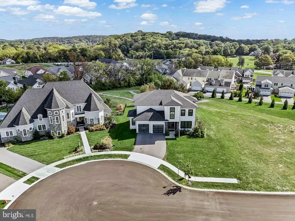 an aerial view of a house with a big yard