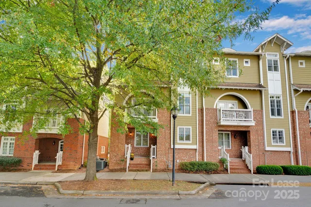 front view of a brick house with a yard