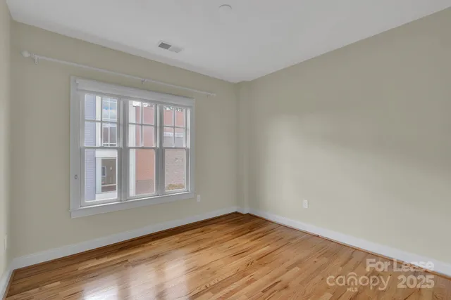a view of an empty room and wooden floor