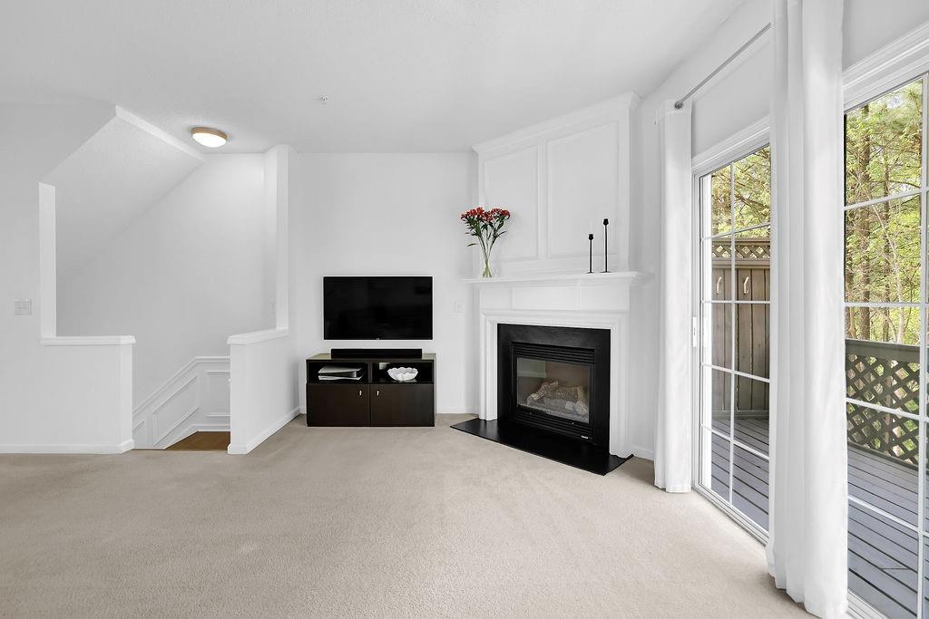 215 Riverstone Commons Circle Canton, GA 30114 - Photo 14 of 36 a living room with furniture a flat screen tv and a fireplace