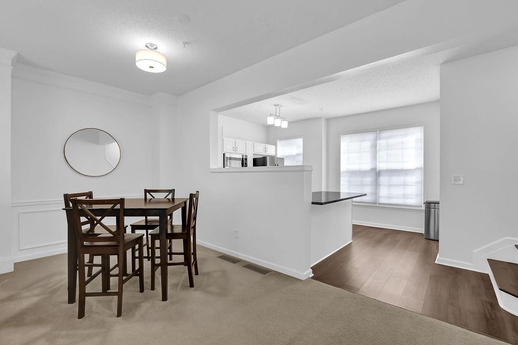 215 Riverstone Commons Circle Canton, GA 30114 - Photo 16 of 36 a view of a dining room with furniture and chandelier