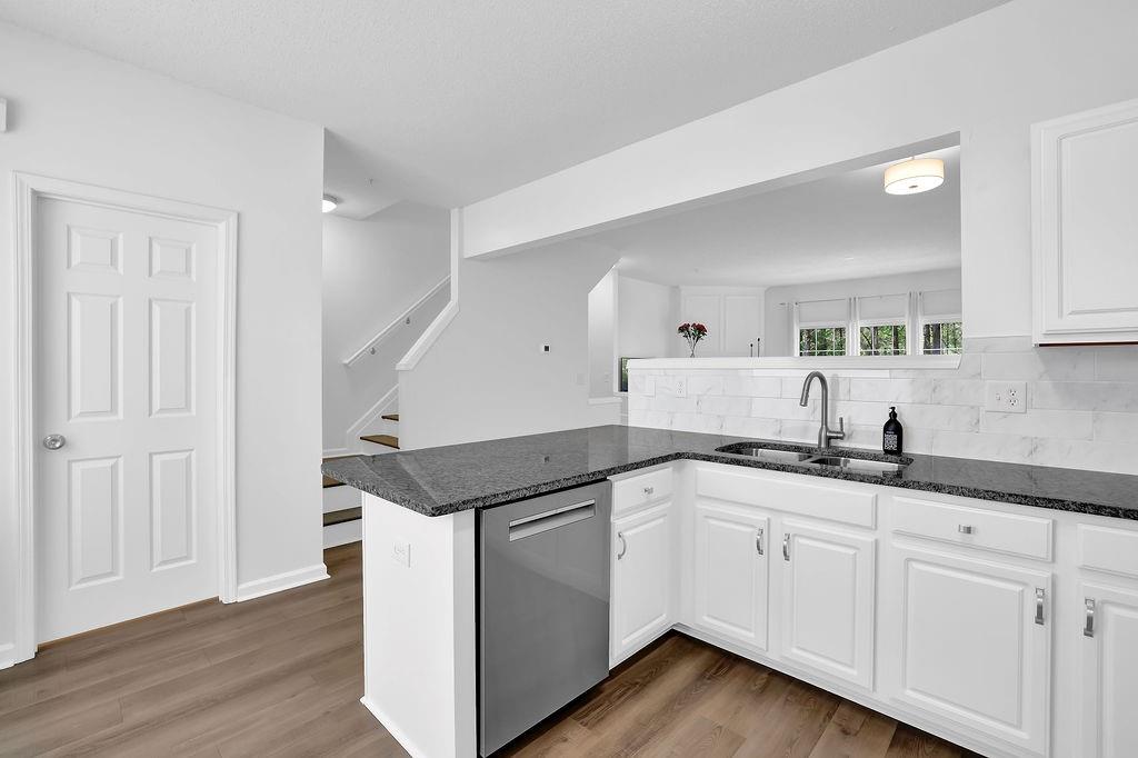 215 Riverstone Commons Circle Canton, GA 30114 - Photo 19 of 36 a kitchen with granite countertop a sink and cabinets