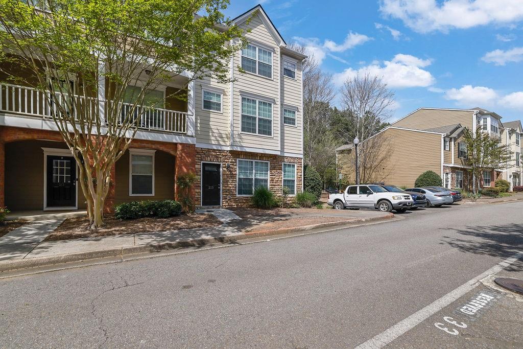 215 Riverstone Commons Circle Canton, GA 30114 - Photo 3 of 36 a view of a street with a building in the background