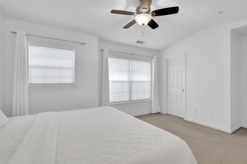 215 Riverstone Commons Circle Canton, GA 30114 - Photo 31 of 36 a bedroom with a large bed and a window
