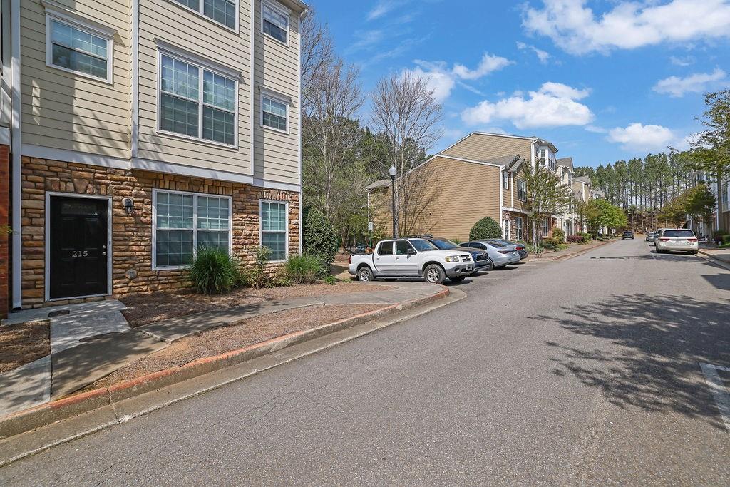 215 Riverstone Commons Circle Canton, GA 30114 - Photo 4 of 36 a car parked on the side of a street