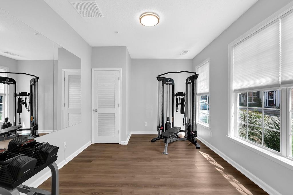 215 Riverstone Commons Circle Canton, GA 30114 - Photo 9 of 36 a view of a room with gym equipment and large windows