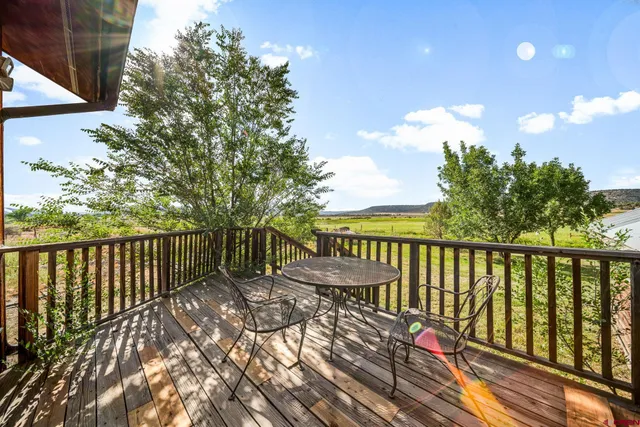 a view of balcony with wooden floor and fence