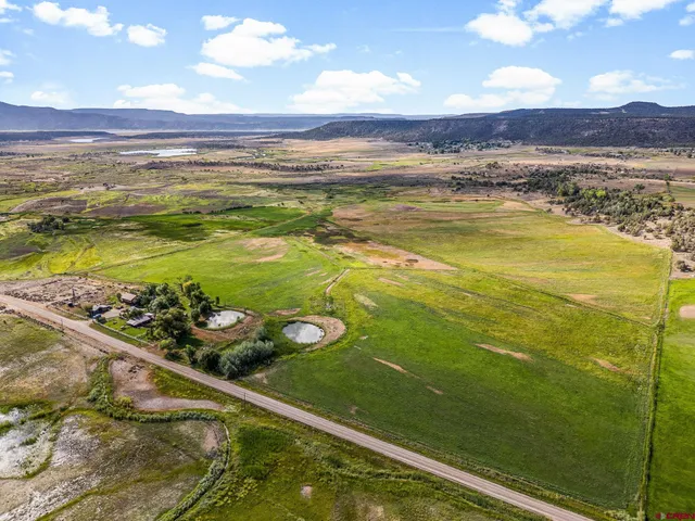 a view of a lake with houses in the back