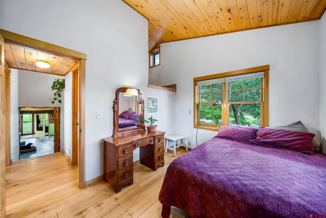 a bed sitting in a bedroom next to a window