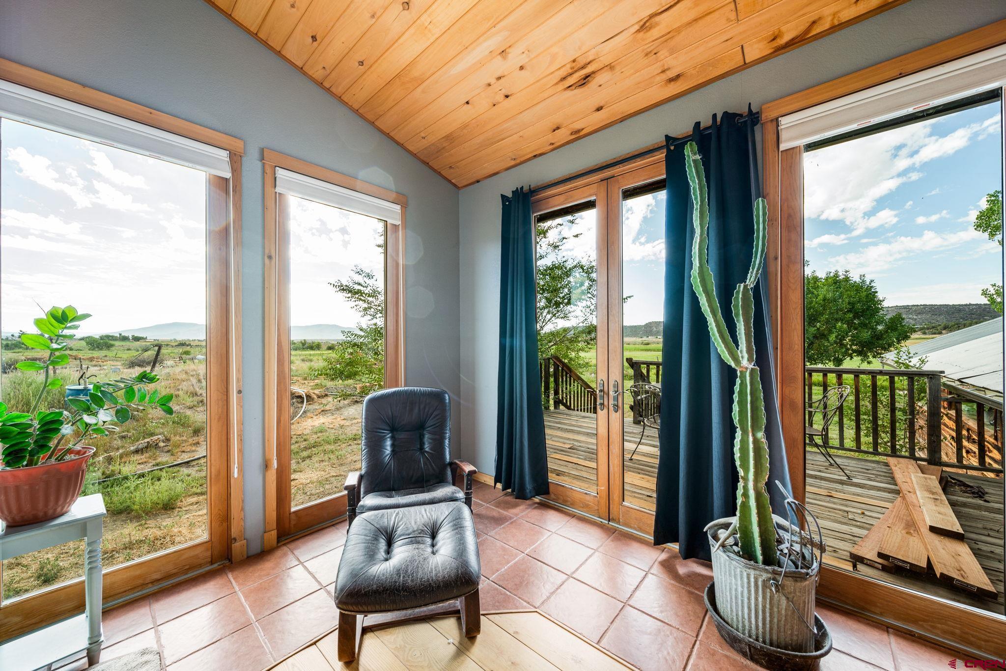 1204 County Road 332 Ignacio, CO 81137 - Photo 9 of 38 a living room with furniture and a floor to ceiling window