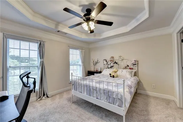 a bedroom with a bed and a ceiling fan