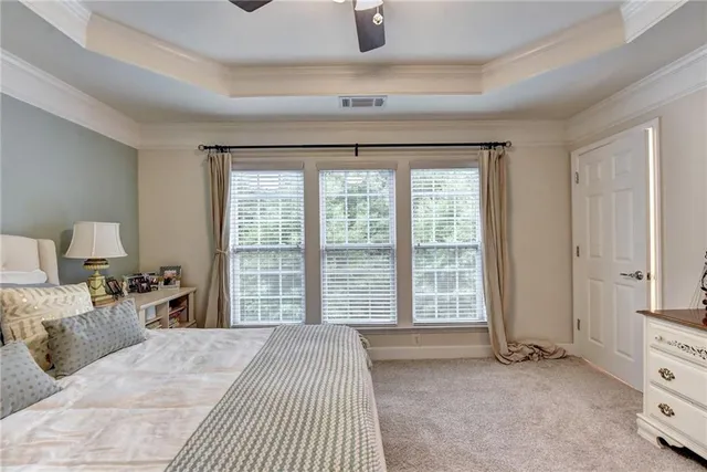 a bedroom with a bed and a large window