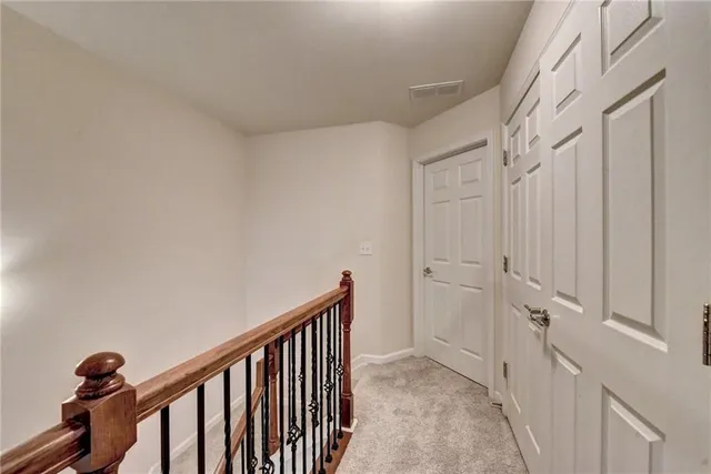 a view of entryway bedroom and hall with wooden floor