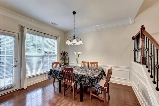 a kitchen with kitchen island granite countertop a sink cabinets and stainless steel appliances