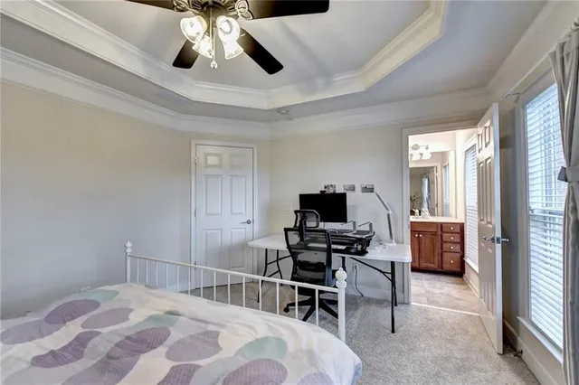 a bedroom with a large bed and a ceiling fan