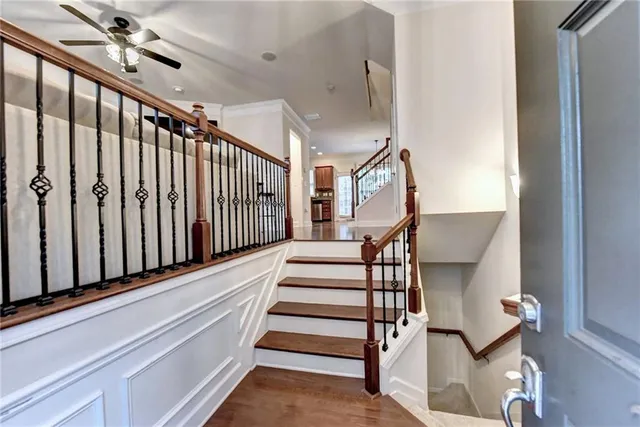 a balcony with wooden floor and trees in the back