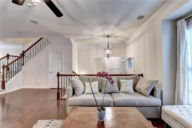 a living room with furniture and wooden floor