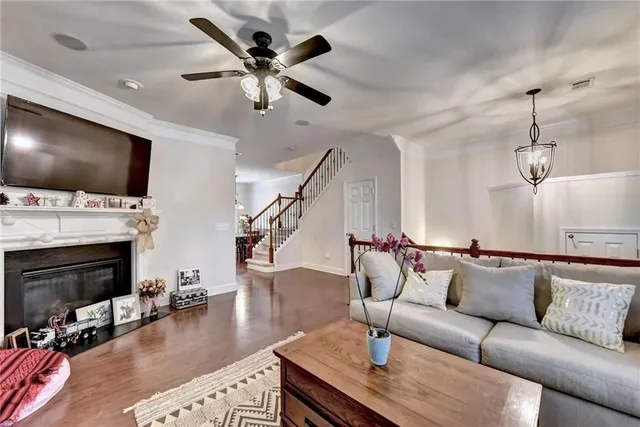 a living room with fireplace furniture and a flat screen tv
