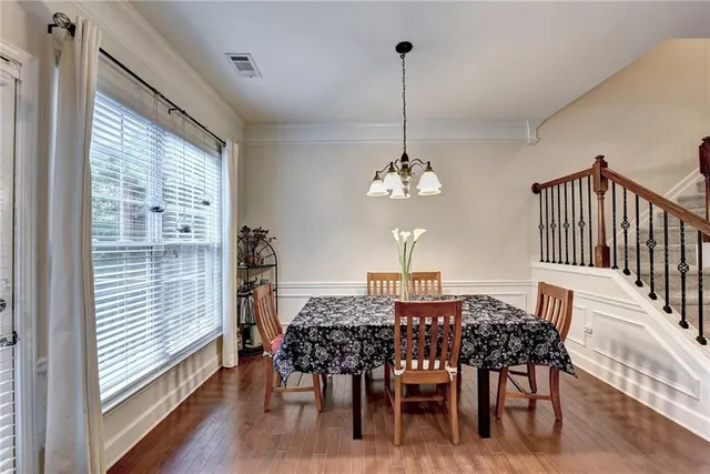 a view of a dining room with furniture window and wooden floor