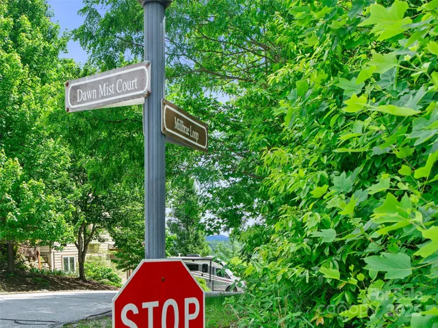 a sign broad in front of the tree