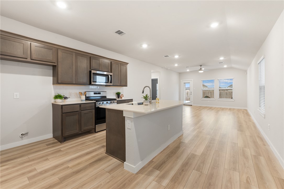 918 Kickapoo Lane College Station, TX 77845 - Photo 11 of 31 a kitchen with a sink window and stainless steel appliances