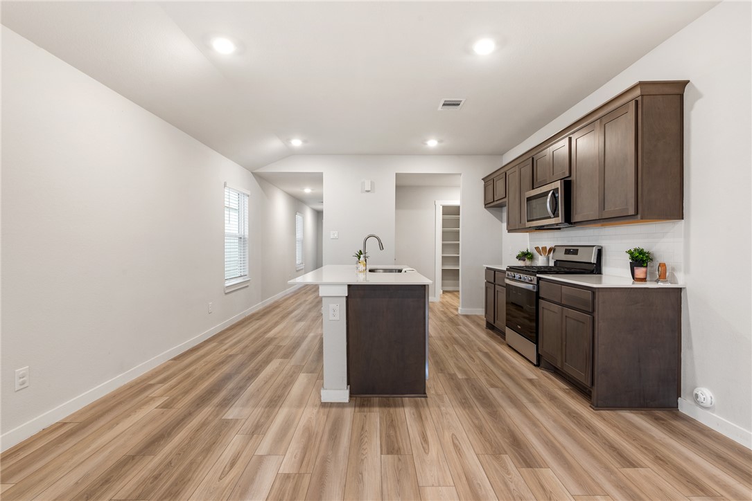 918 Kickapoo Lane College Station, TX 77845 - Photo 14 of 31 a kitchen with a refrigerator and a stove top oven