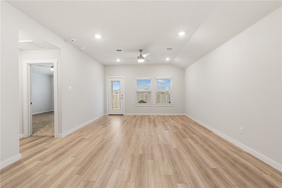 918 Kickapoo Lane College Station, TX 77845 - Photo 16 of 31 an empty room with wooden floor and windows