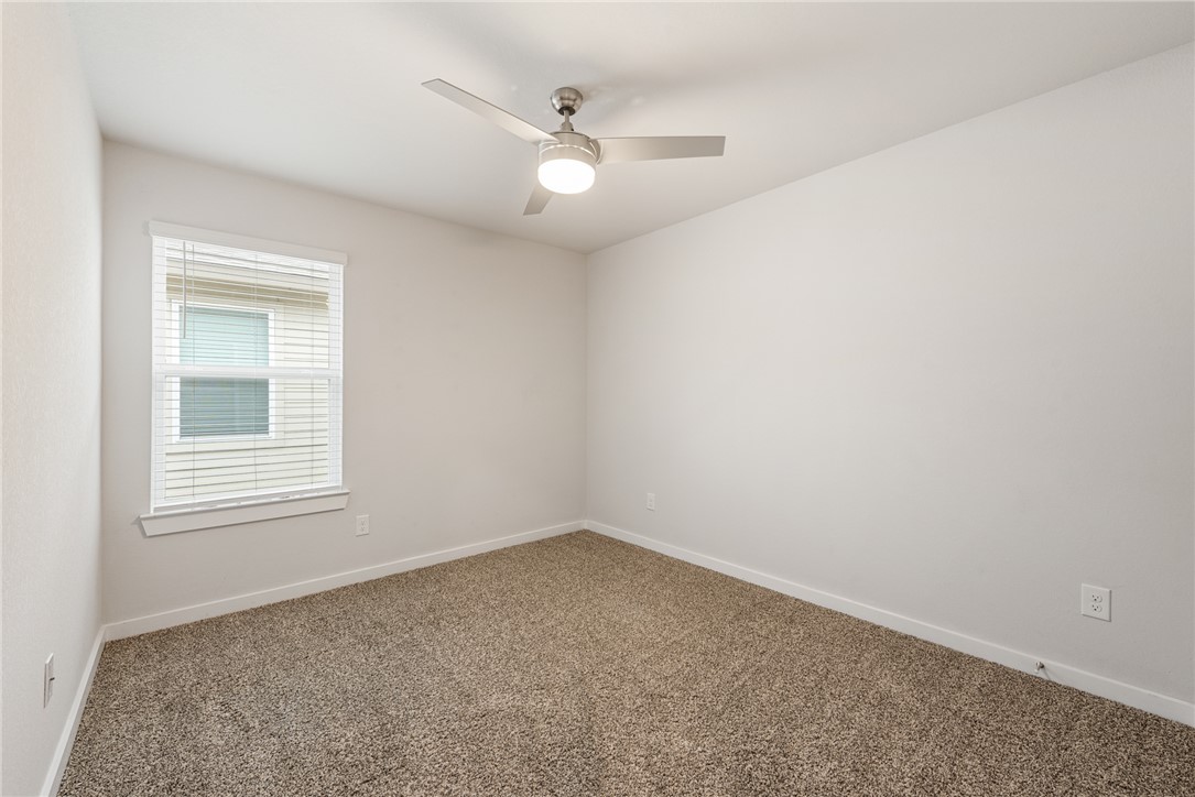 918 Kickapoo Lane College Station, TX 77845 - Photo 28 of 31 an empty room with a chandelier fan and windows