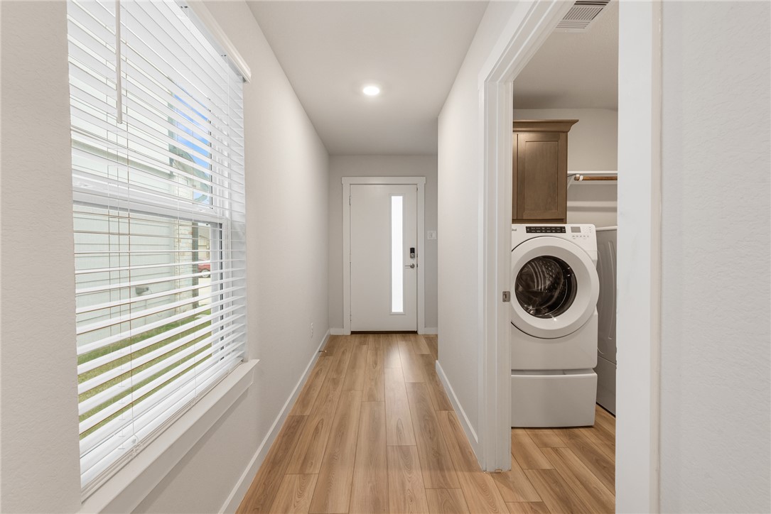 918 Kickapoo Lane College Station, TX 77845 - Photo 10 of 31 a view of a hallway with washer and dryer