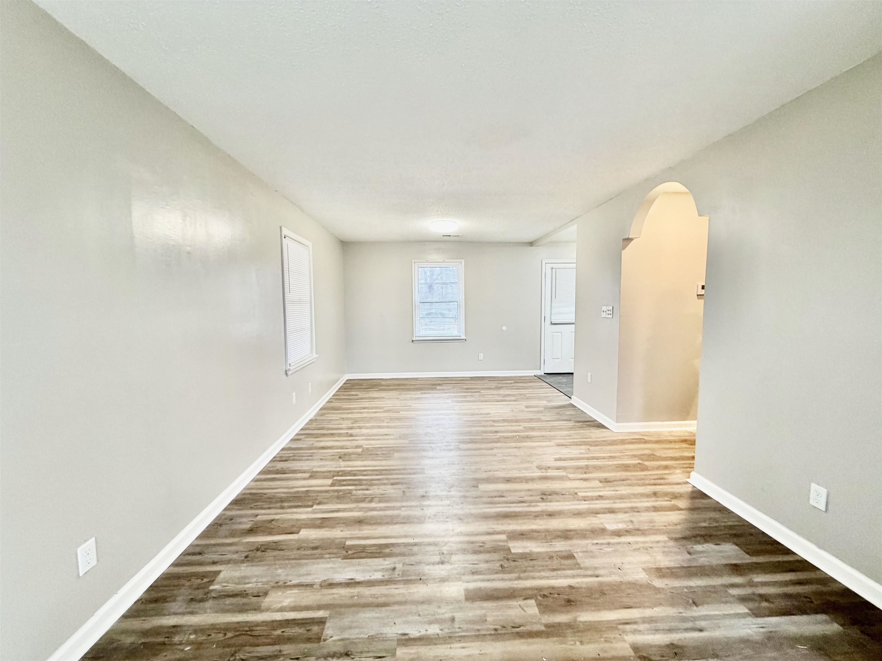 3345 Charlotte Road Memphis, TN 38109 - Photo 8 of 10 Dining room with arched walkways and light wood-style flooring