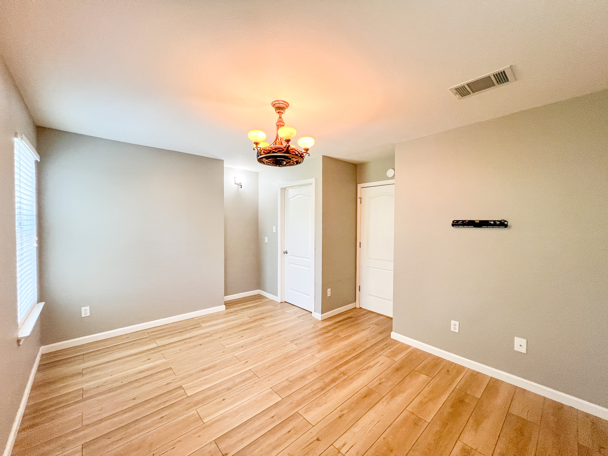 298 Jack Rabbit Lane Buda, TX 78610 - Photo 8 of 24 Natural wood flooring complements the neutral walls, creating an inviting space.