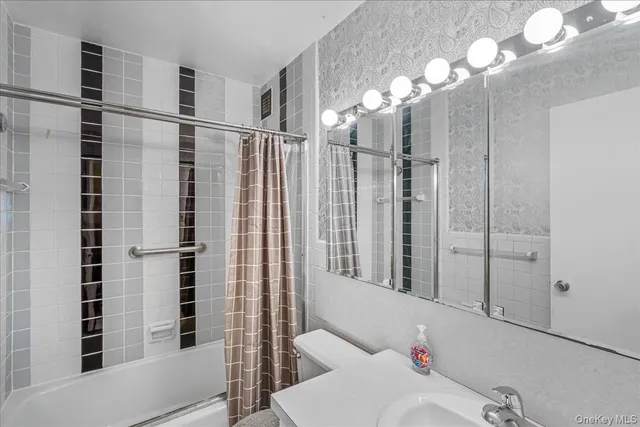 a bathroom with a shower and a mirror