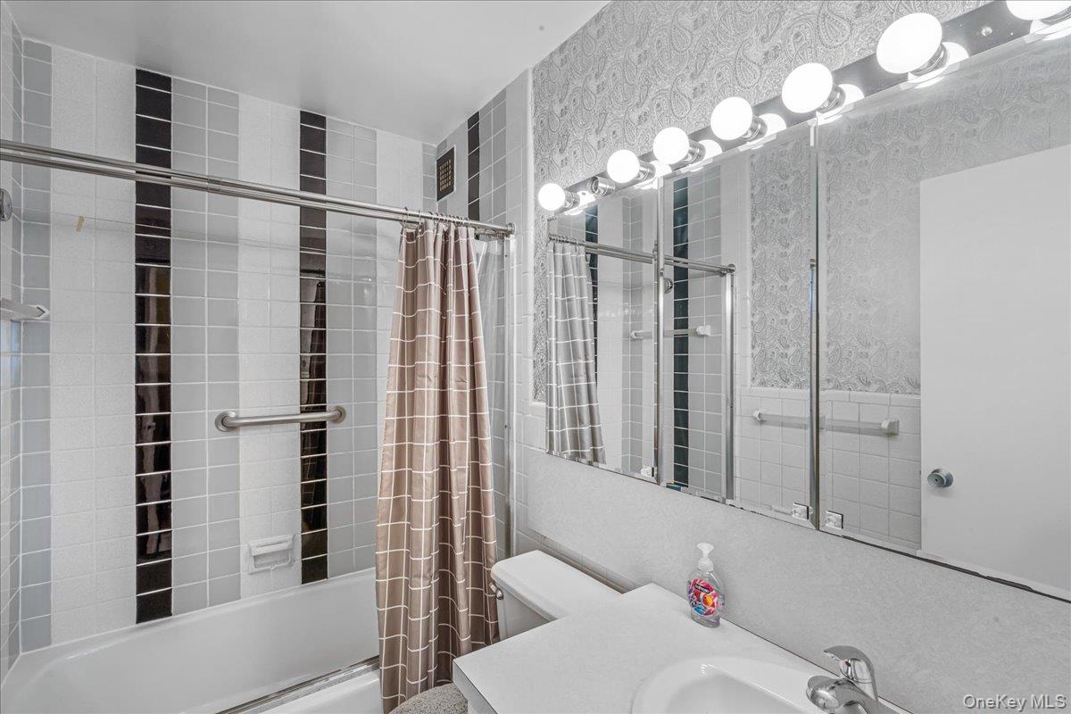 17-85 215th Street, Unit 6A Queens, NY 11360 - Photo 16 of 36 a bathroom with a shower and a mirror