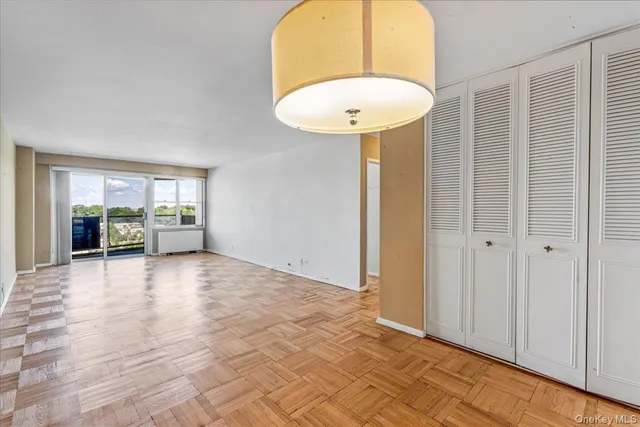 an empty room with a door and wooden floor