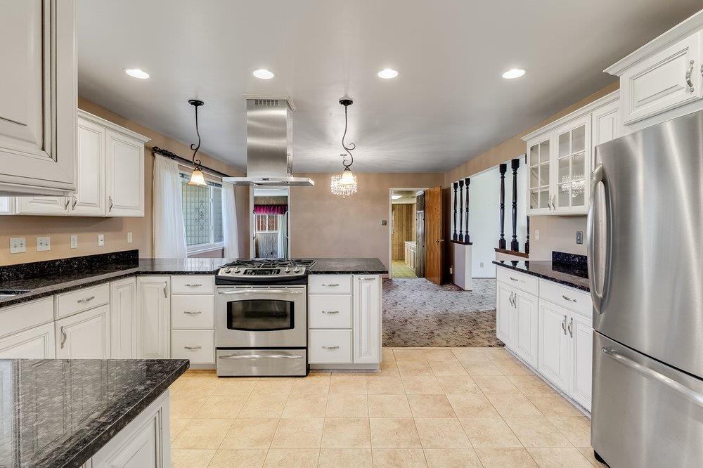 10486 Spaulding Way Rancho Cordova, CA 95670 - Photo 12 of 74 a large kitchen with stainless steel appliances granite countertop a stove and a sink
