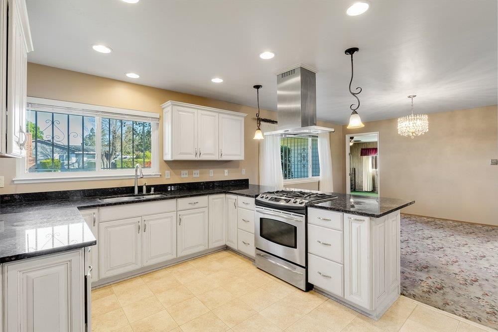 10486 Spaulding Way Rancho Cordova, CA 95670 - Photo 13 of 74 a kitchen with stainless steel appliances granite countertop a stove a sink and a microwave