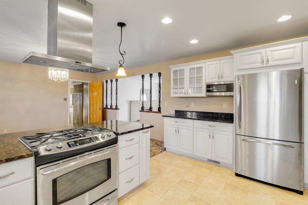 10486 Spaulding Way Rancho Cordova, CA 95670 - Photo 16 of 74 a kitchen with stainless steel appliances granite countertop a stove a refrigerator and a stove top oven