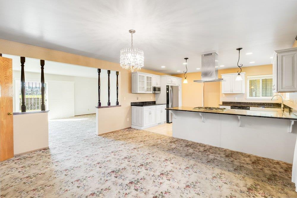 10486 Spaulding Way Rancho Cordova, CA 95670 - Photo 20 of 74 a view of a kitchen with kitchen island wooden floor and stainless steel appliances